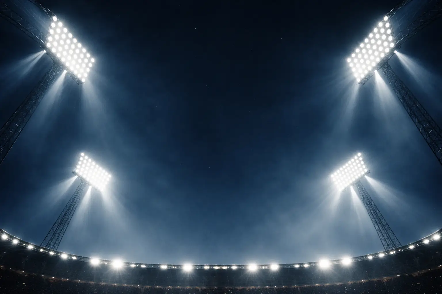 Flutlichtmasten eines großen Stadions leuchten in den Nachthimmel vor dem Anpfiff